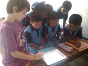 Jude showing the children in India how to use the iPad 